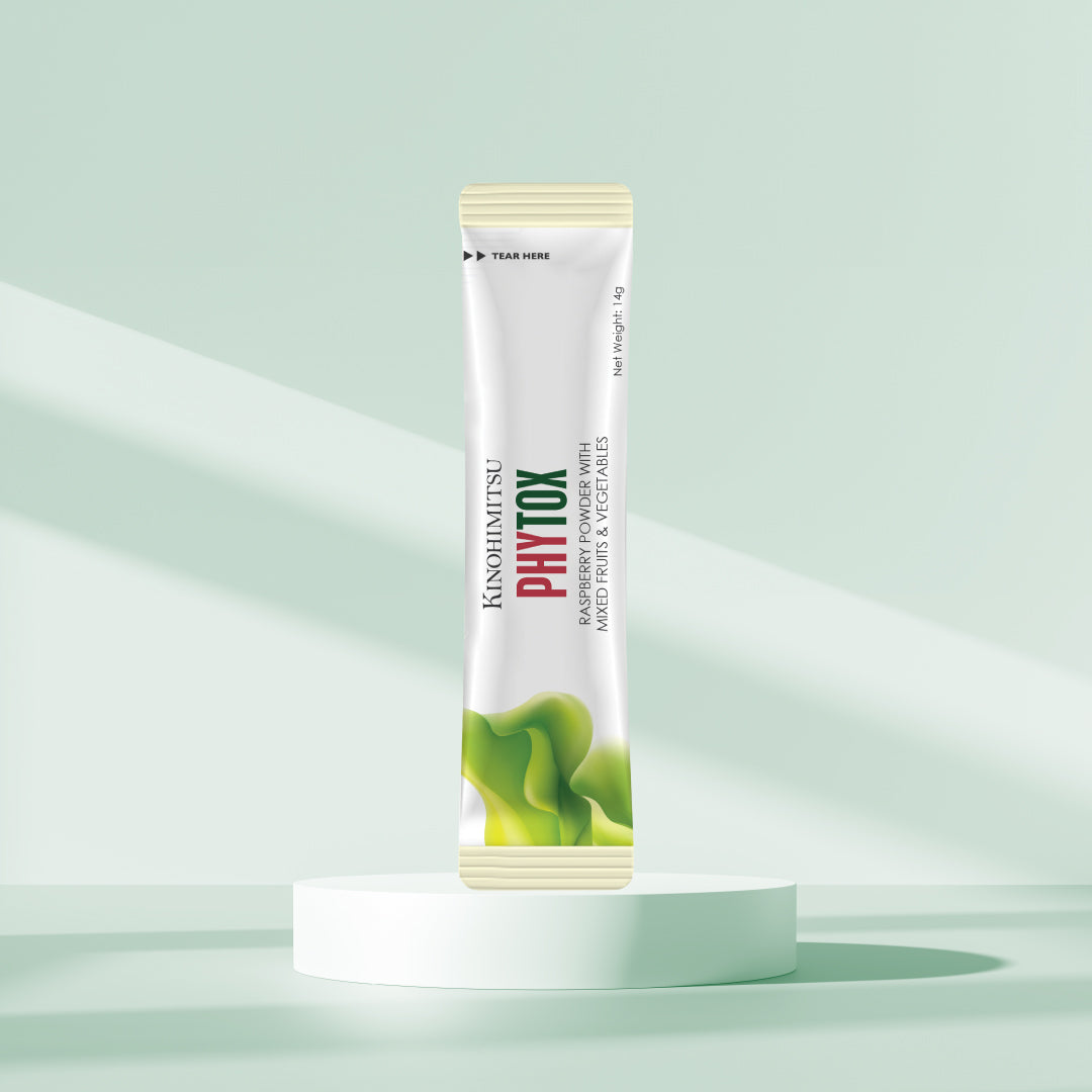 Kinohimitsu Phytox sachet on a minimalist pedestal, featuring raspberry powder with mixed fruits and vegetables blend, against a light green background.