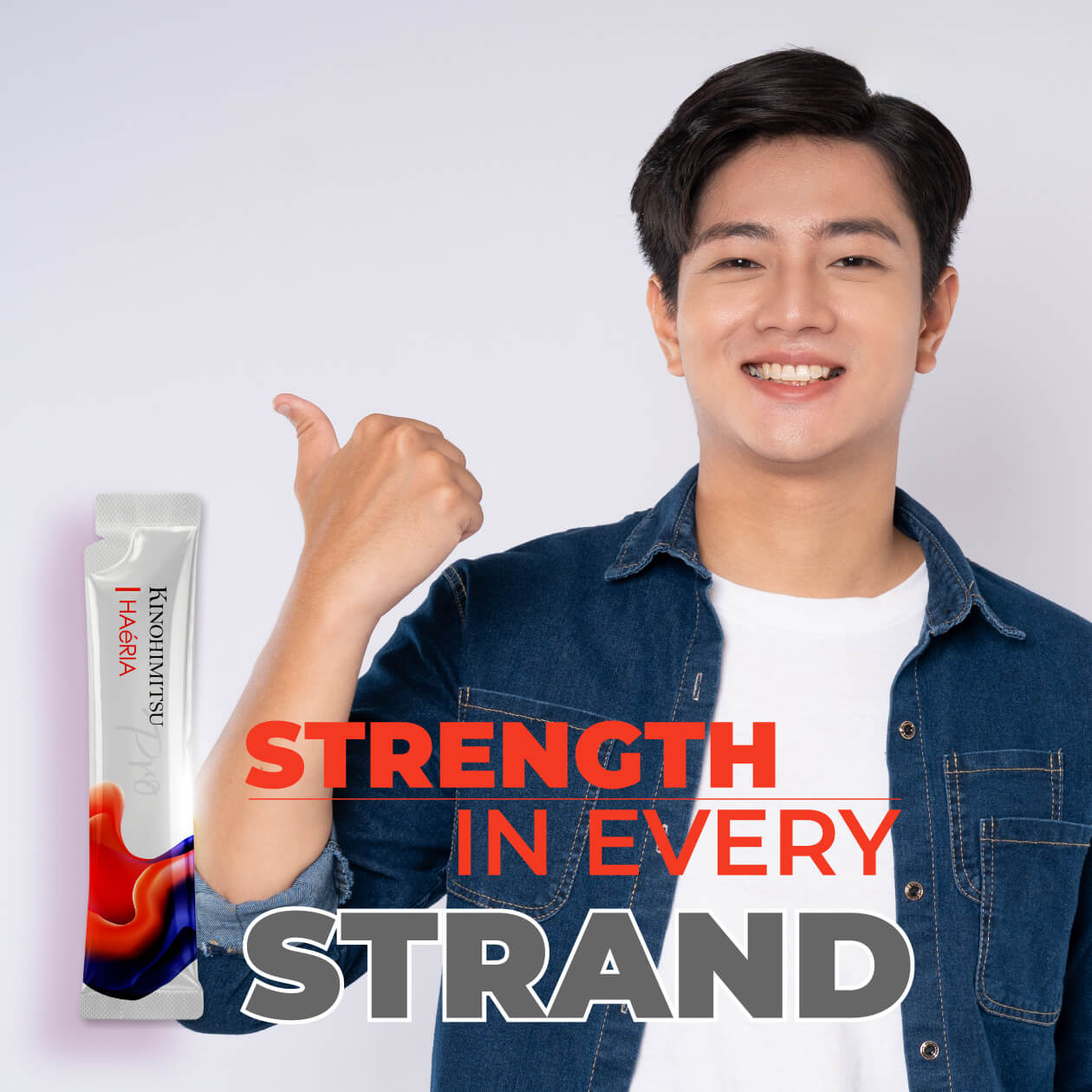 Young man holding Kinohimitsu Haéria Pro hair supplement sachet with thumbs up, promoting strength in every hair strand and hair loss prevention