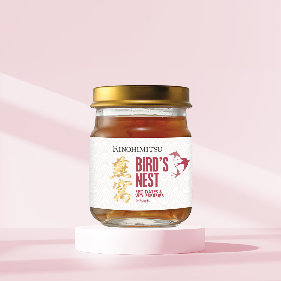 Kinohimitsu Bird's Nest Red Dates & Wolfberries drink jar with gold cap on pink background, promoting skin health and immunity. Kinohimitsu Bird's Nest Red Dates & Wolfberries Superfruit Drink in a glass jar with a gold lid, set against a pink background. Promotes skin health and immunity.