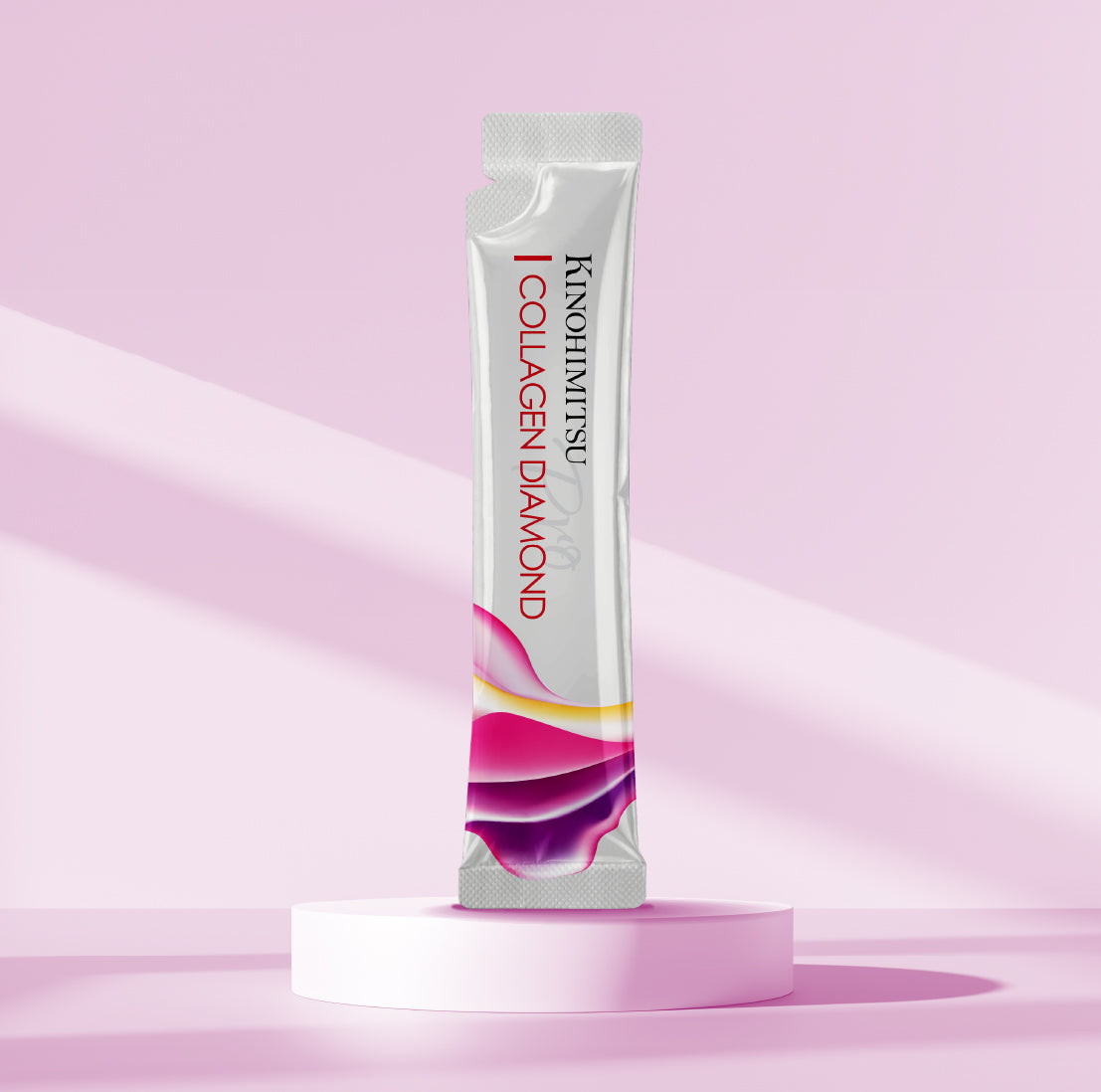 Kinohimitsu Collagen Diamond Pro sachet on pink podium, marine collagen beauty drink for skin firming and anti-ageing.