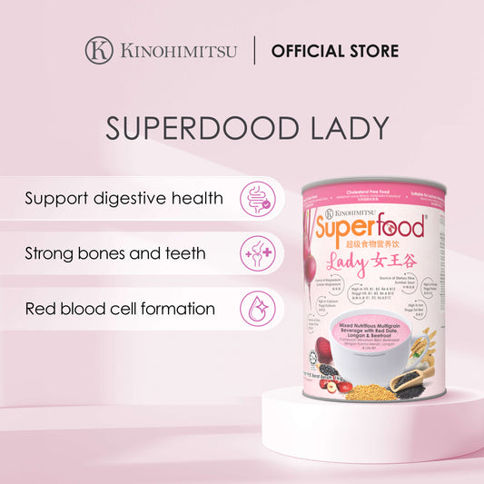 Kinohimitsu Superfood Lady product advertisement highlighting benefits such as digestive health support, strong bones and teeth, and red blood cell formation. The image features the product packaging with details of ingredients like red date, longan, and beetroot, set against a pink background.