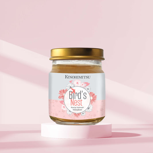 Jar of Kinohimitsu Organic Bird's Nest with Kacip Fatimah and Manjakani on a pink background, highlighting women's health benefits.