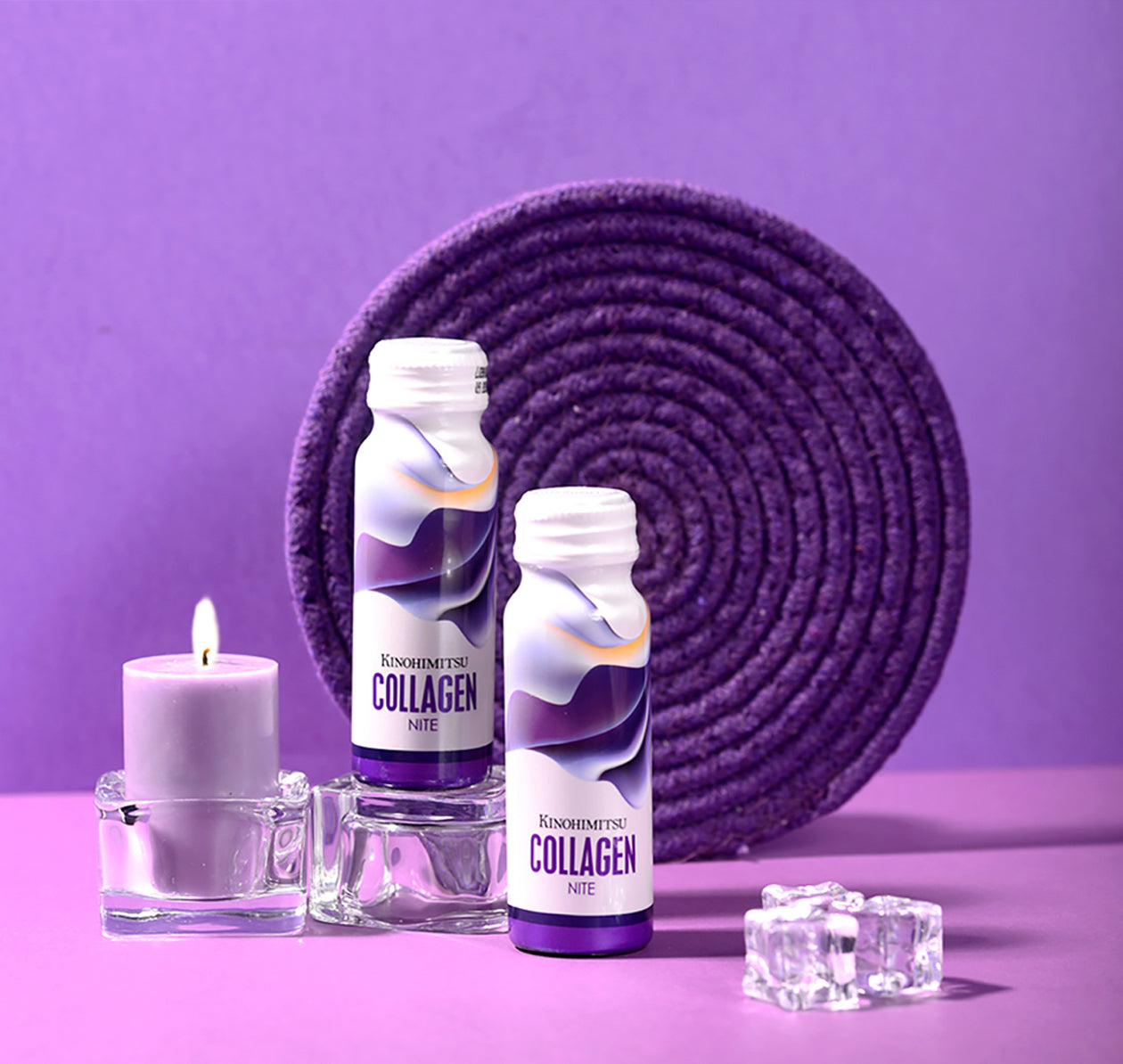 Kinohimitsu Collagen Nite bottles displayed on a purple surface with a purple circular mat and a lit candle, promoting beauty and skincare in Malaysia.