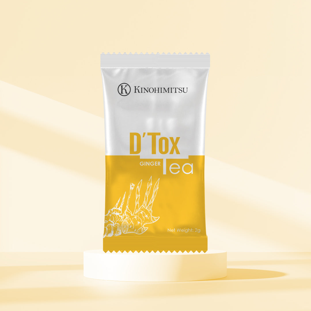 Pouch of Kinohimitsu D'Tox Tea Ginger displayed on a minimalistic beige background, featuring sleek packaging design with ginger illustration and product label. Weight specified as 2g.