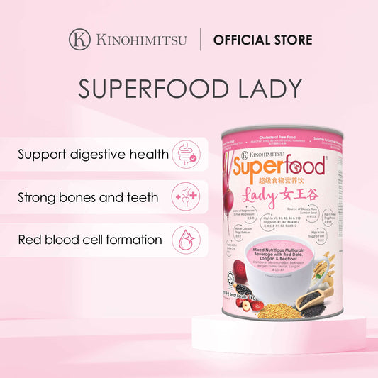 Kinohimitsu Superfood Lady product advertisement highlighting benefits such as digestive health support, strong bones and teeth, and red blood cell formation. The image features the product packaging with details of ingredients like red date, longan, and beetroot, set against a pink background.